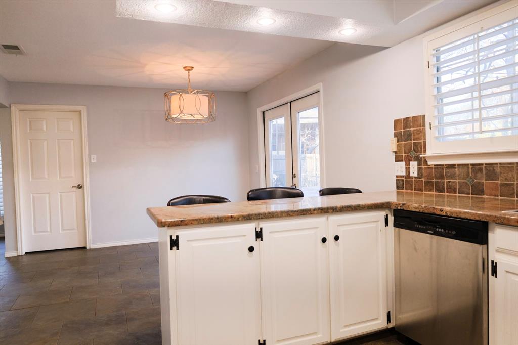 740 Peavy Road Dallas, TX 75218 - Photo 6 of 19 a kitchen with a sink cabinets and window