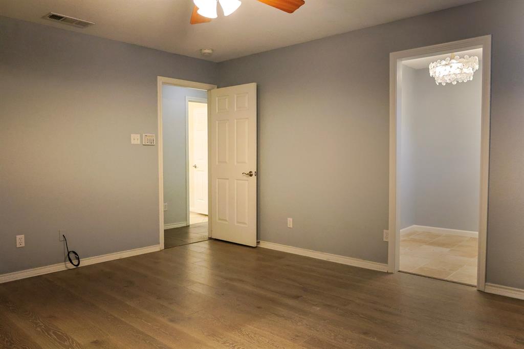 740 Peavy Road Dallas, TX 75218 - Photo 9 of 19 an empty room with wooden floor and windows