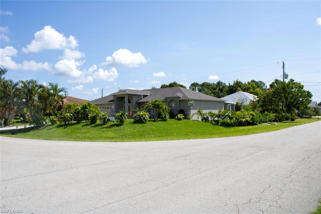 17565 Butler Road Fort Myers, FL 33967 - Photo 1 of 12 a view of a house with a big yard and a large trees