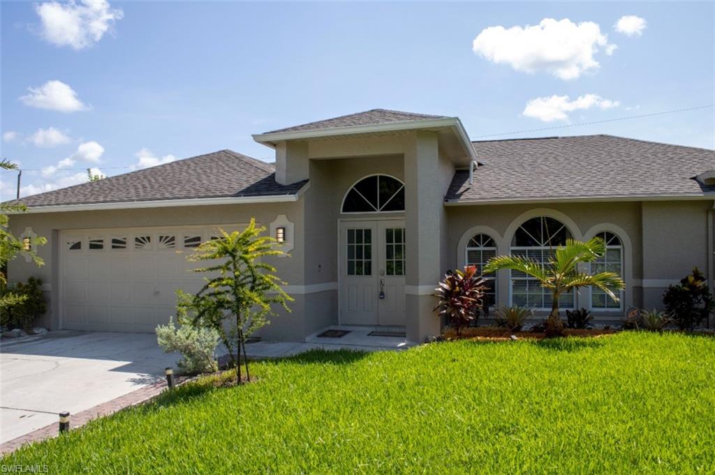 17565 Butler Road Fort Myers, FL 33967 - Photo 3 of 12 a front view of a house with garden