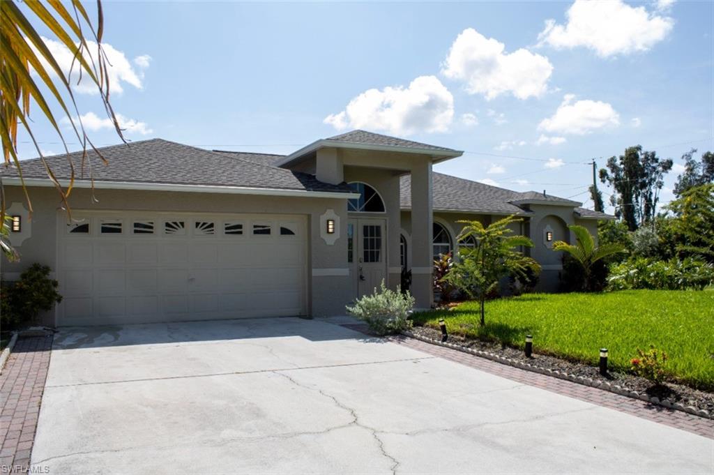 17565 Butler Road Fort Myers, FL 33967 - Photo 4 of 12 a front view of a house with garden