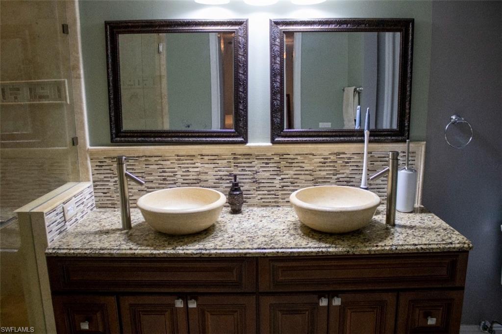 17565 Butler Road Fort Myers, FL 33967 - Photo 10 of 12 a bathroom with a granite countertop sink a mirror and wooden