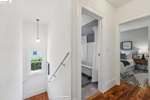 a view of a livingroom with wooden floor and furniture