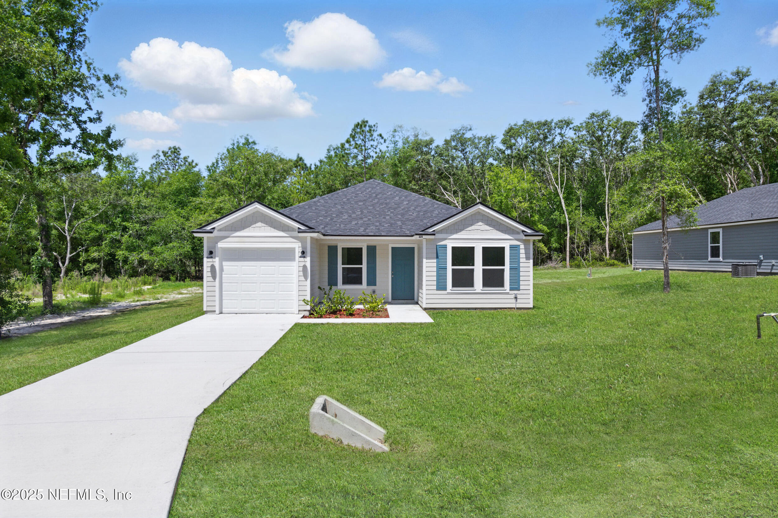 a aerial view of a house with yard and green space