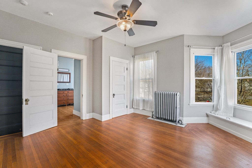 175 High Street Taunton, MA 02780 - Photo 14 of 39 a view of a livingroom with wooden floor and a ceiling fan