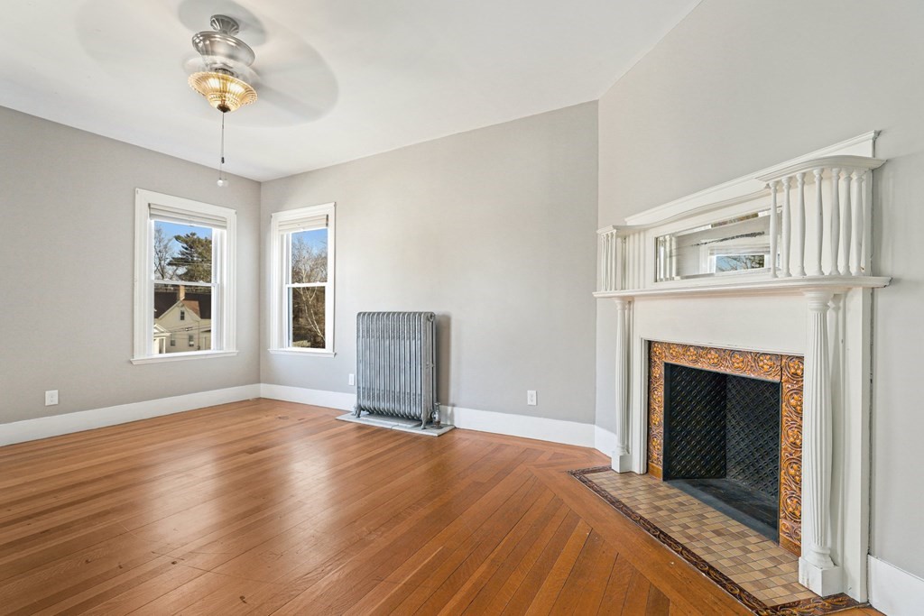 175 High Street Taunton, MA 02780 - Photo 18 of 39 a view of livingroom with window fireplace and wooden floor