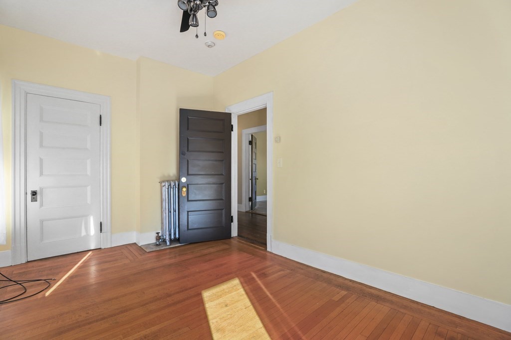175 High Street Taunton, MA 02780 - Photo 21 of 39 a view of empty room with wooden floor and fan