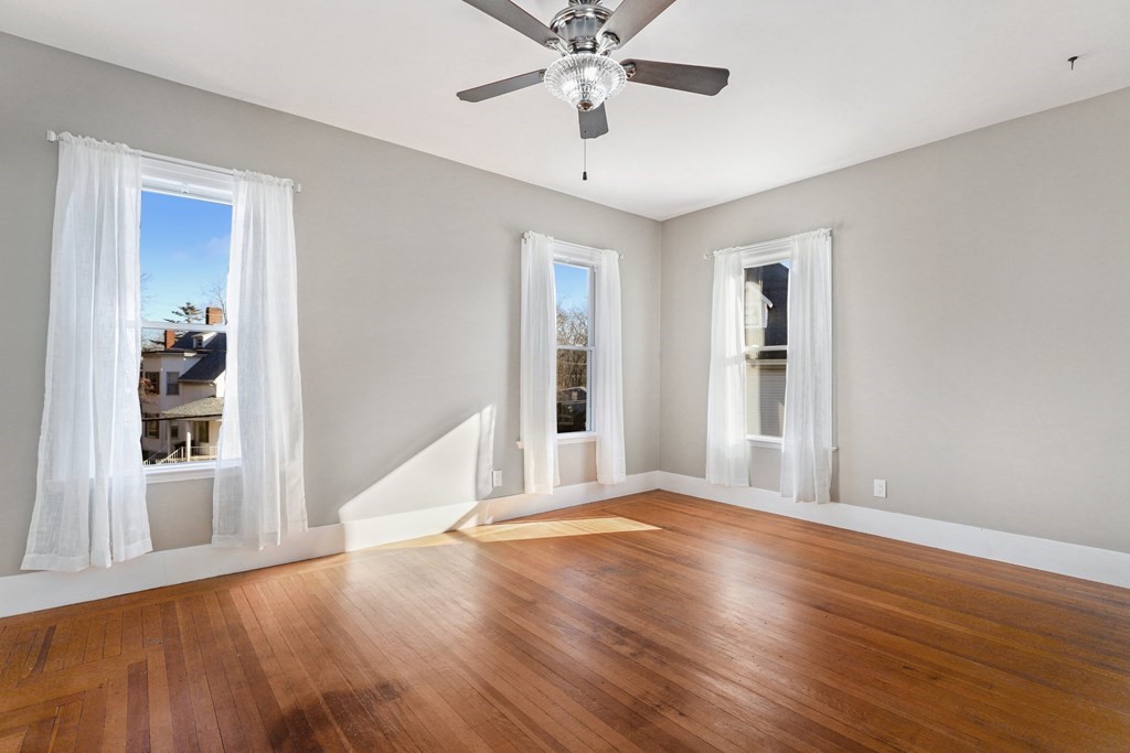 175 High Street Taunton, MA 02780 - Photo 25 of 39 a view of an empty room with window and wooden floor