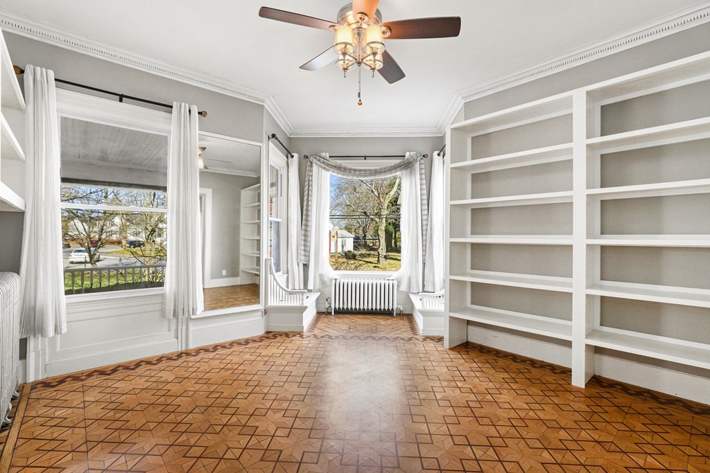 175 High Street Taunton, MA 02780 - Photo 6 of 39 a view of an empty room with a window and wooden floor
