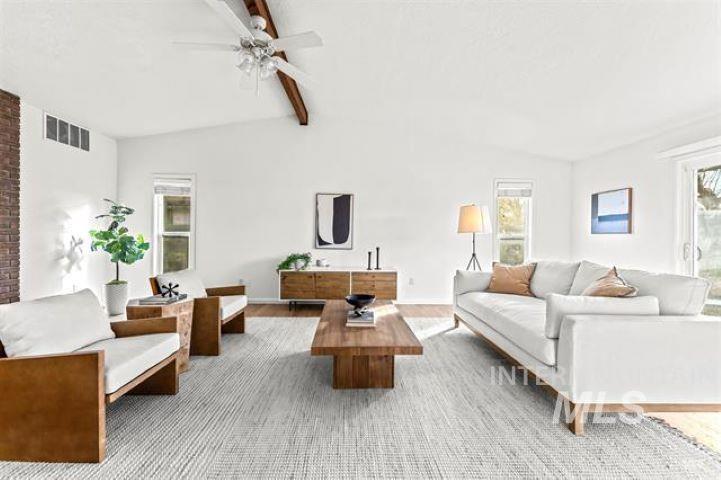 2481 West Rebecca Way Meridian, ID 83646 - Photo 3 of 17 Living area with lofted ceiling with beams, ceiling fan, and wood finished floors