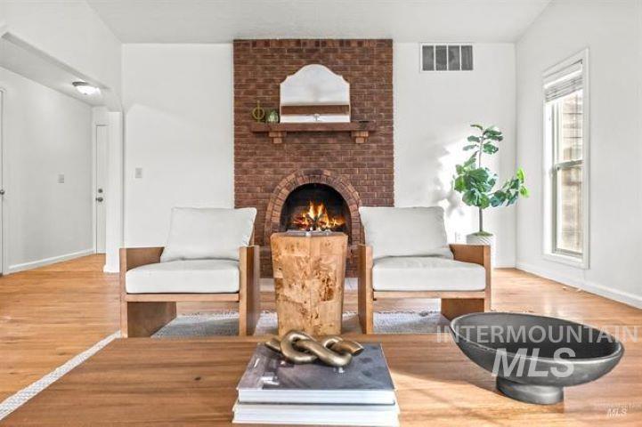 2481 West Rebecca Way Meridian, ID 83646 - Photo 4 of 17 Sitting room featuring a fireplace and light wood-style floors