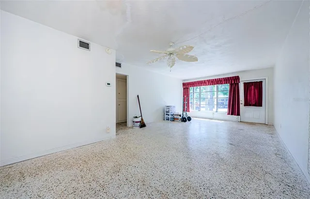 a view of a livingroom with furniture and a window