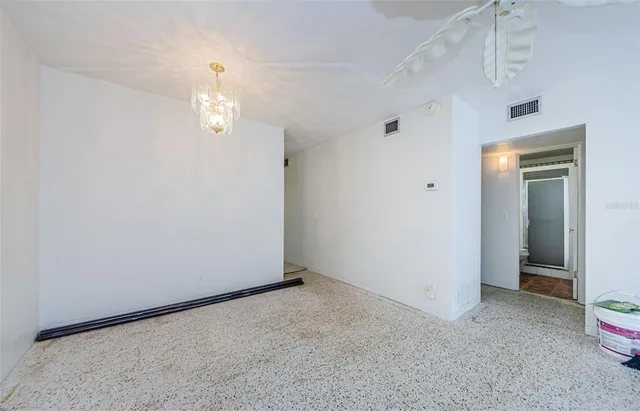 a kitchen with a refrigerator a stove top oven and cabinets