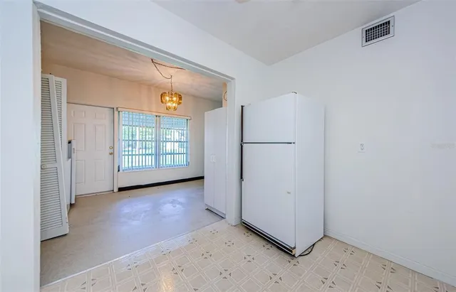 an empty room with fan and entrance