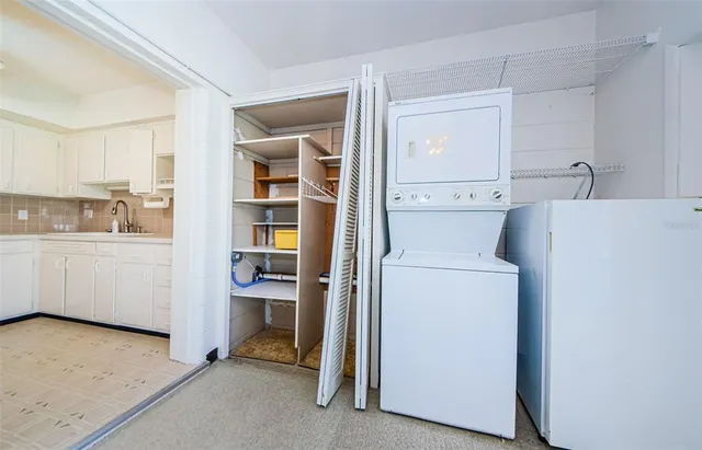 a view of a house with a big yard potted plants and large tree