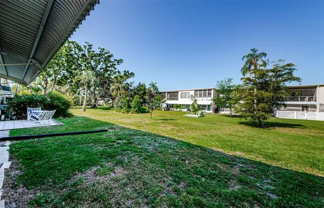 a dining room with lots of furniture and a large window