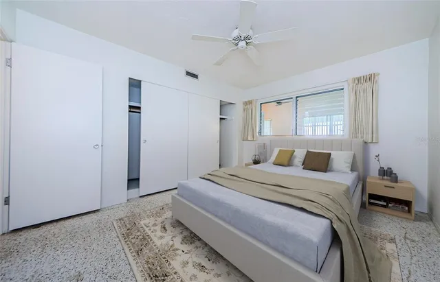 a bedroom with a large bed and a chandelier