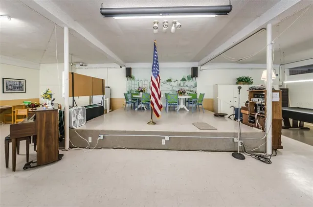 a kitchen with stainless steel appliances granite countertop a sink a stove and a refrigerator