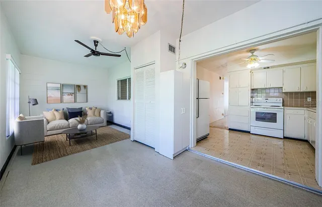 a living room with furniture and kitchen view