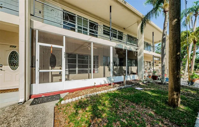 a view of a building with a large window and sitting area