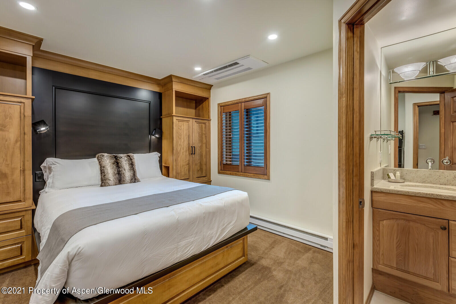 650 South Monarch Street, Unit 6 Aspen, CO 81611 - Photo 12 of 28 a bedroom with a bed and a flat screen tv