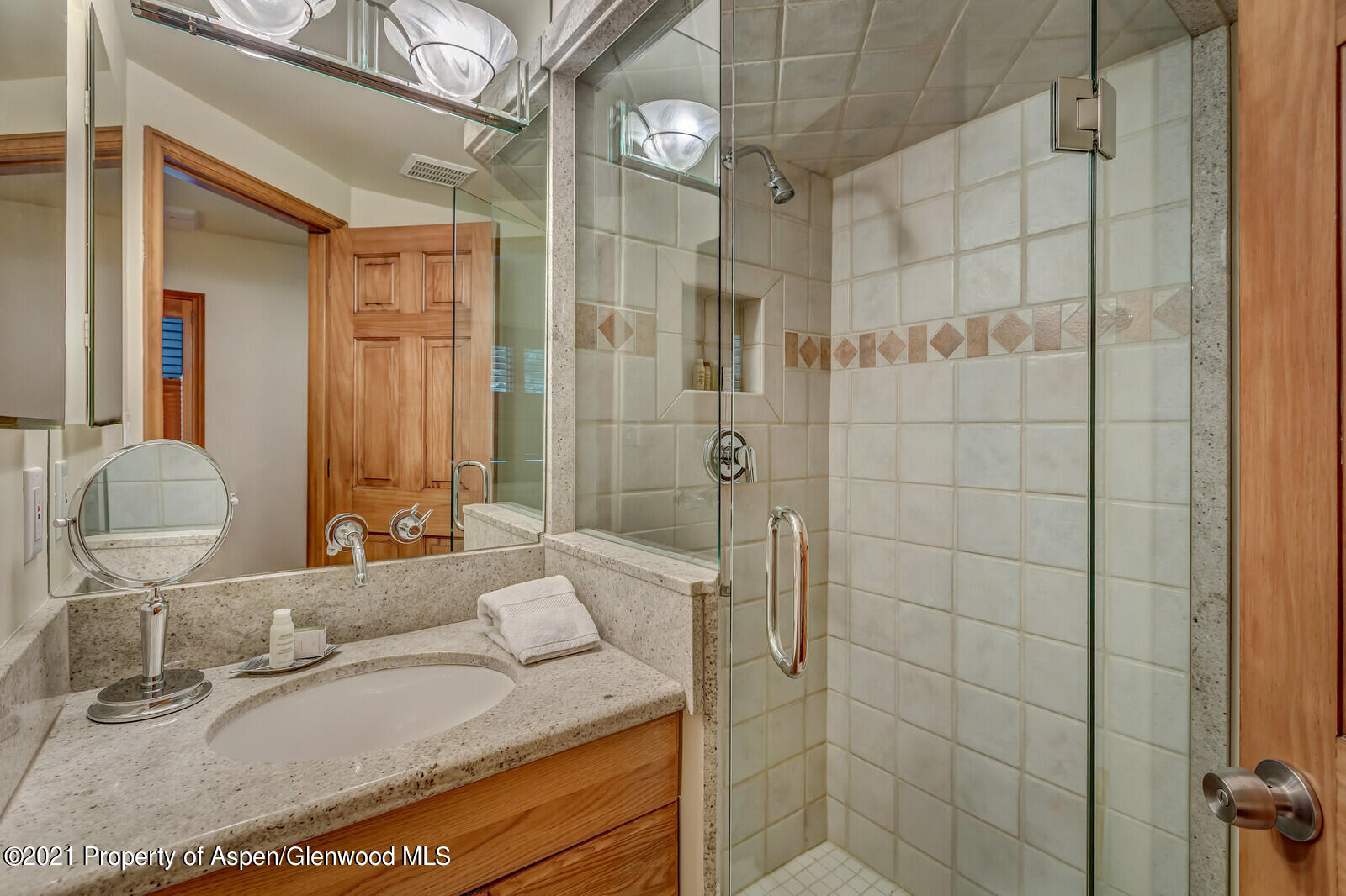 650 South Monarch Street, Unit 6 Aspen, CO 81611 - Photo 20 of 28 a bathroom with a granite countertop sink a mirror and shower