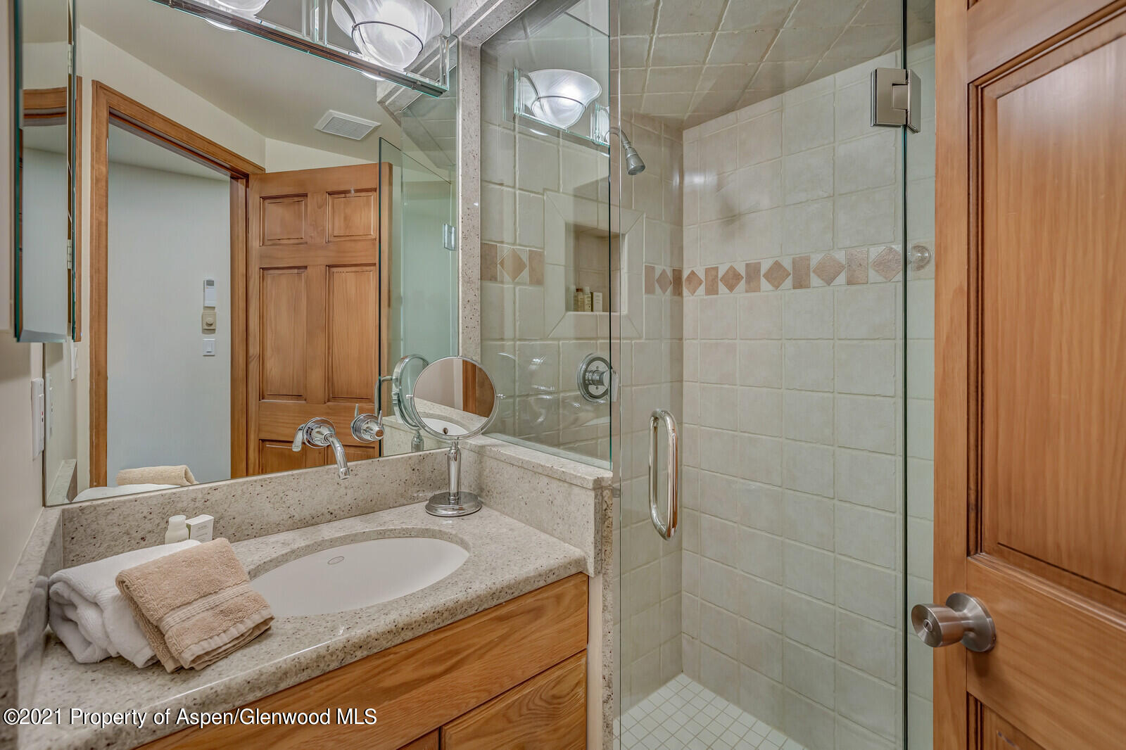 650 South Monarch Street, Unit 6 Aspen, CO 81611 - Photo 21 of 28 a bathroom with a granite countertop sink a mirror and a shower