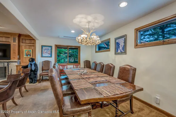 a view of a dining room with furniture and a chandelier