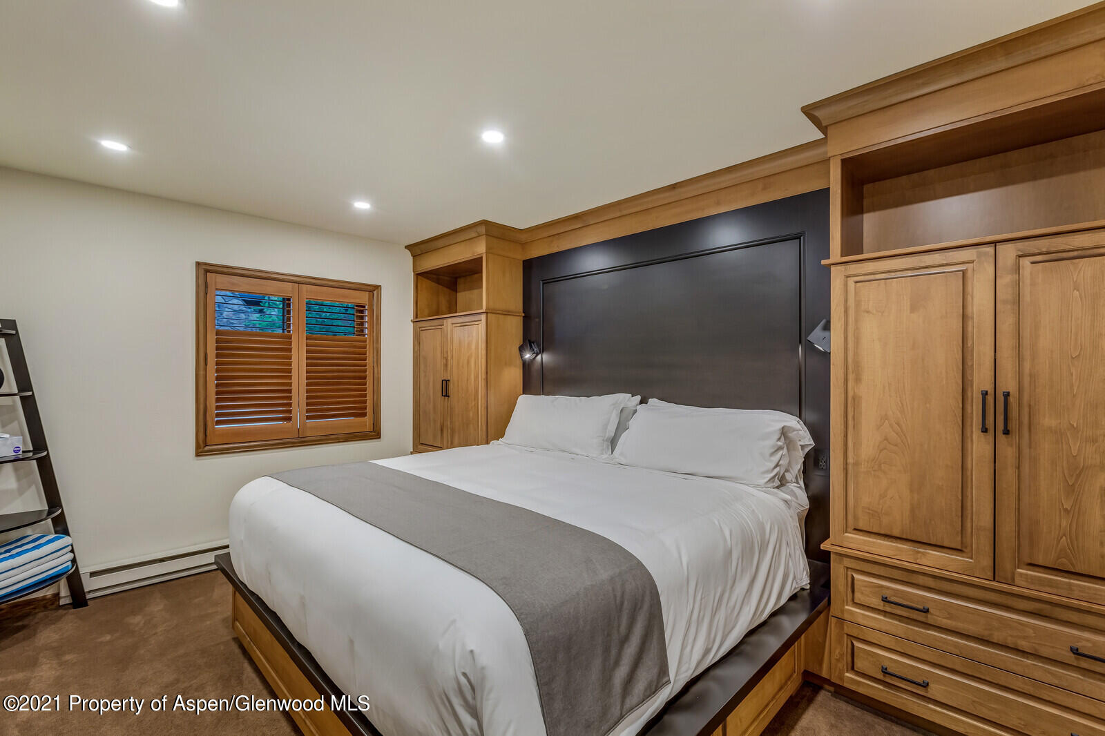 650 South Monarch Street, Unit 6 Aspen, CO 81611 - Photo 8 of 28 a bedroom with a bed and a flat screen tv