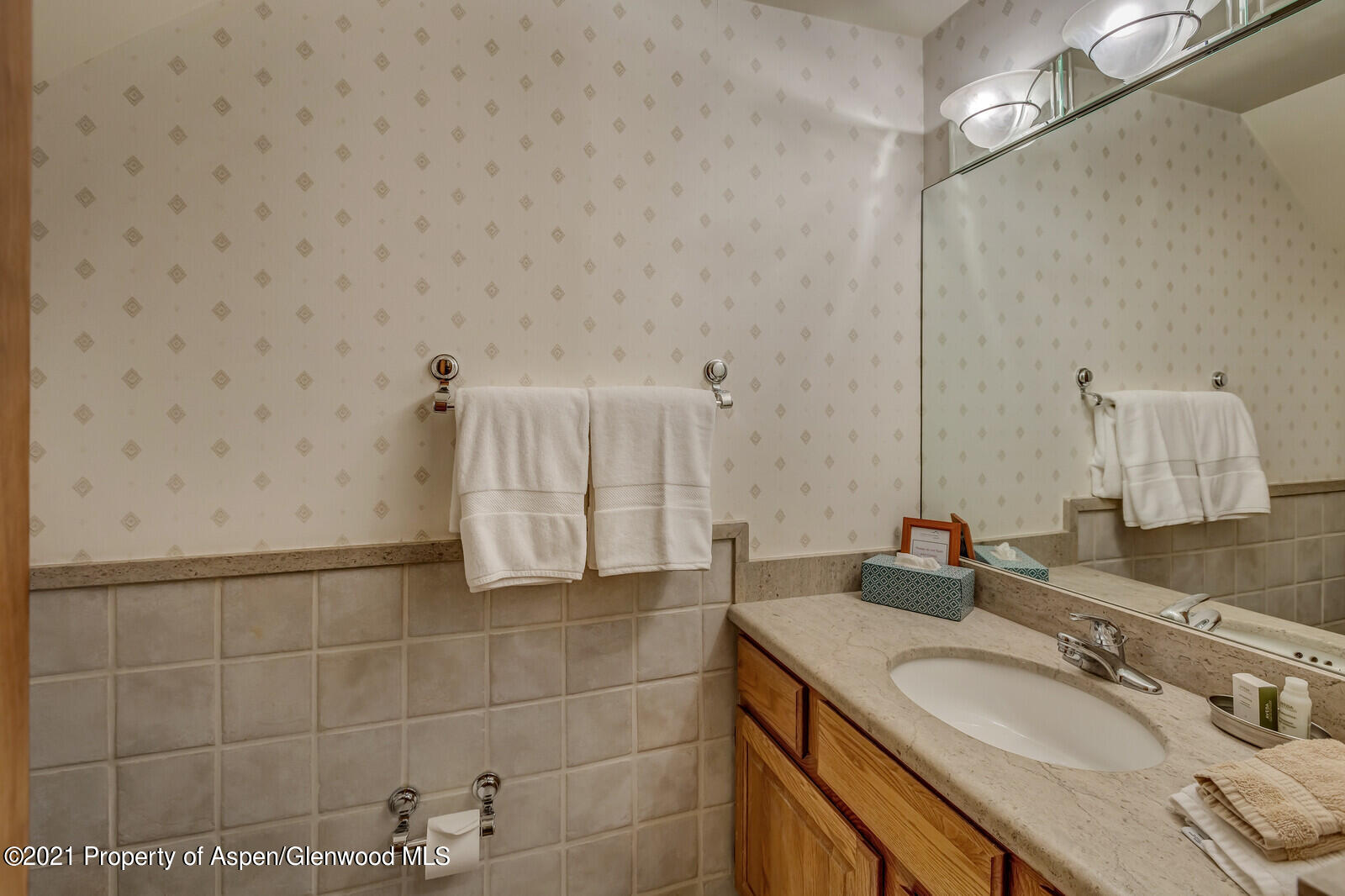 650 South Monarch Street, Unit 6 Aspen, CO 81611 - Photo 10 of 28 a bathroom with a granite countertop sink a mirror and a shower