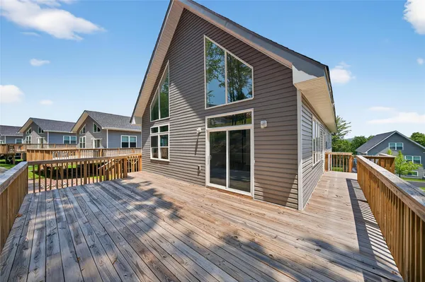 a view of a house with wooden deck