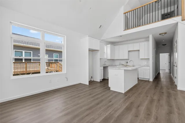 a view of open kitchen with wooden floor and electronic appliances