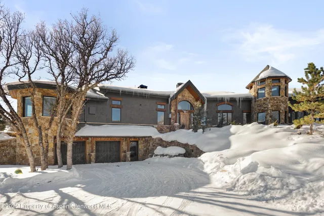 a front view of a house with yard and trees