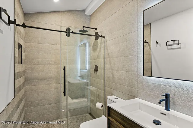 a bathroom with a sink toilet and shower