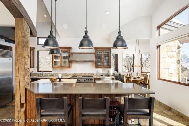 a kitchen with stainless steel appliances a sink stove and cabinets