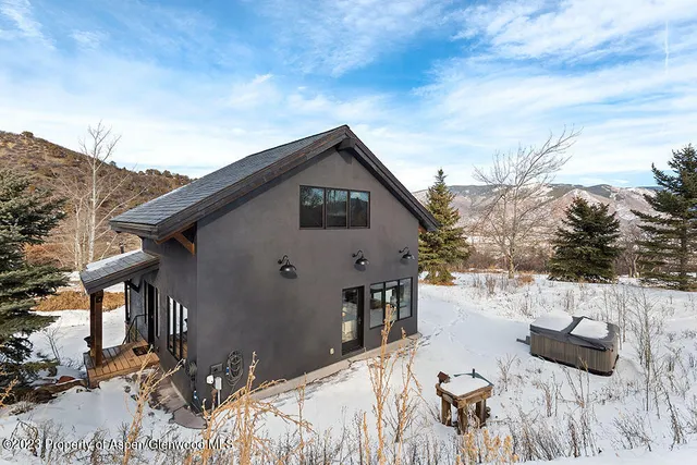 a view of house with yard and covered with snow
