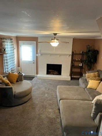 3732 Birdwood Road Richmond, VA 23234 - Photo 24 of 28 a living room with furniture and a fireplace
