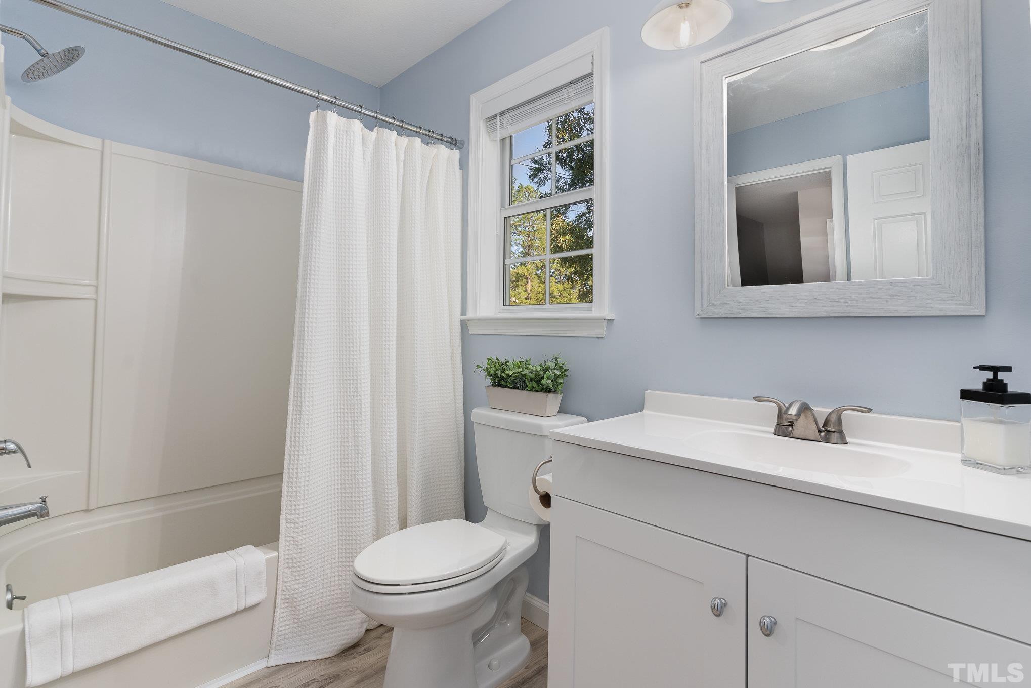 2014 Talloway Drive Cary, NC 27511 - Photo 11 of 18 a bathroom with a sink a toilet and shower