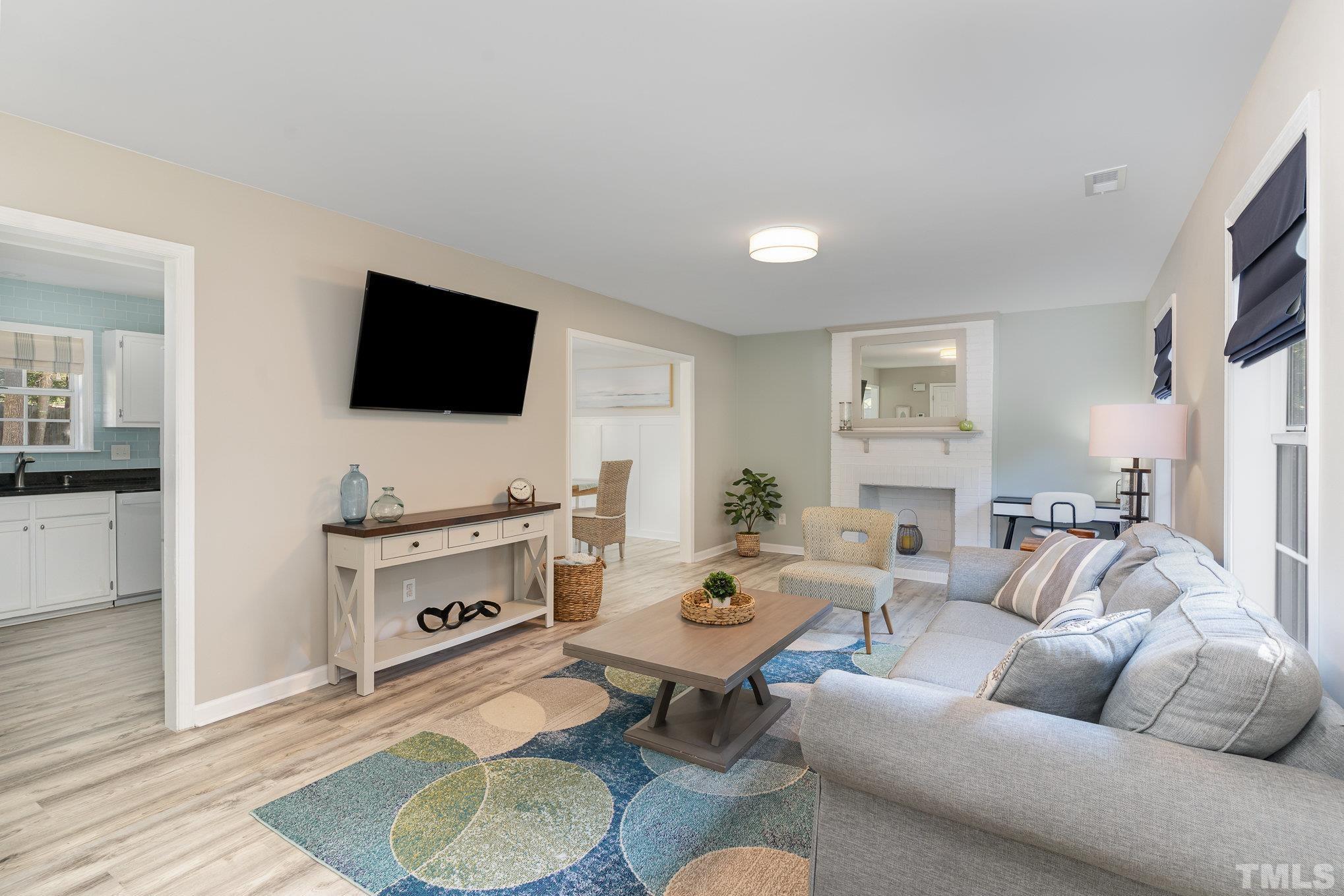2014 Talloway Drive Cary, NC 27511 - Photo 2 of 18 a living room with furniture a flat screen tv and kitchen view