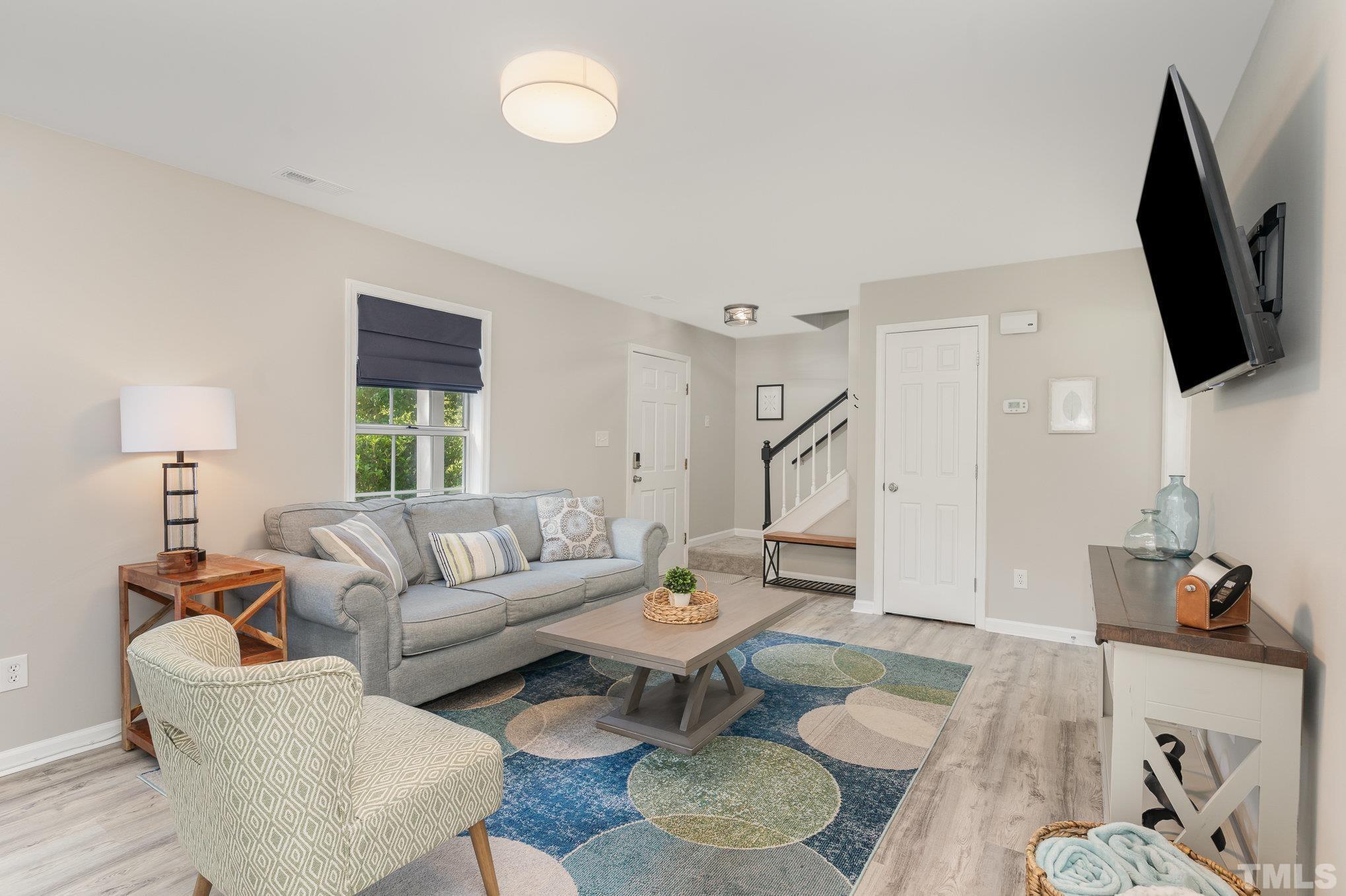 2014 Talloway Drive Cary, NC 27511 - Photo 3 of 18 a living room with furniture and a flat screen tv