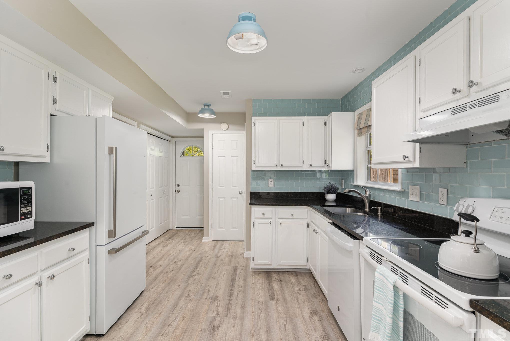 2014 Talloway Drive Cary, NC 27511 - Photo 6 of 18 a kitchen with a sink a stove and cabinets