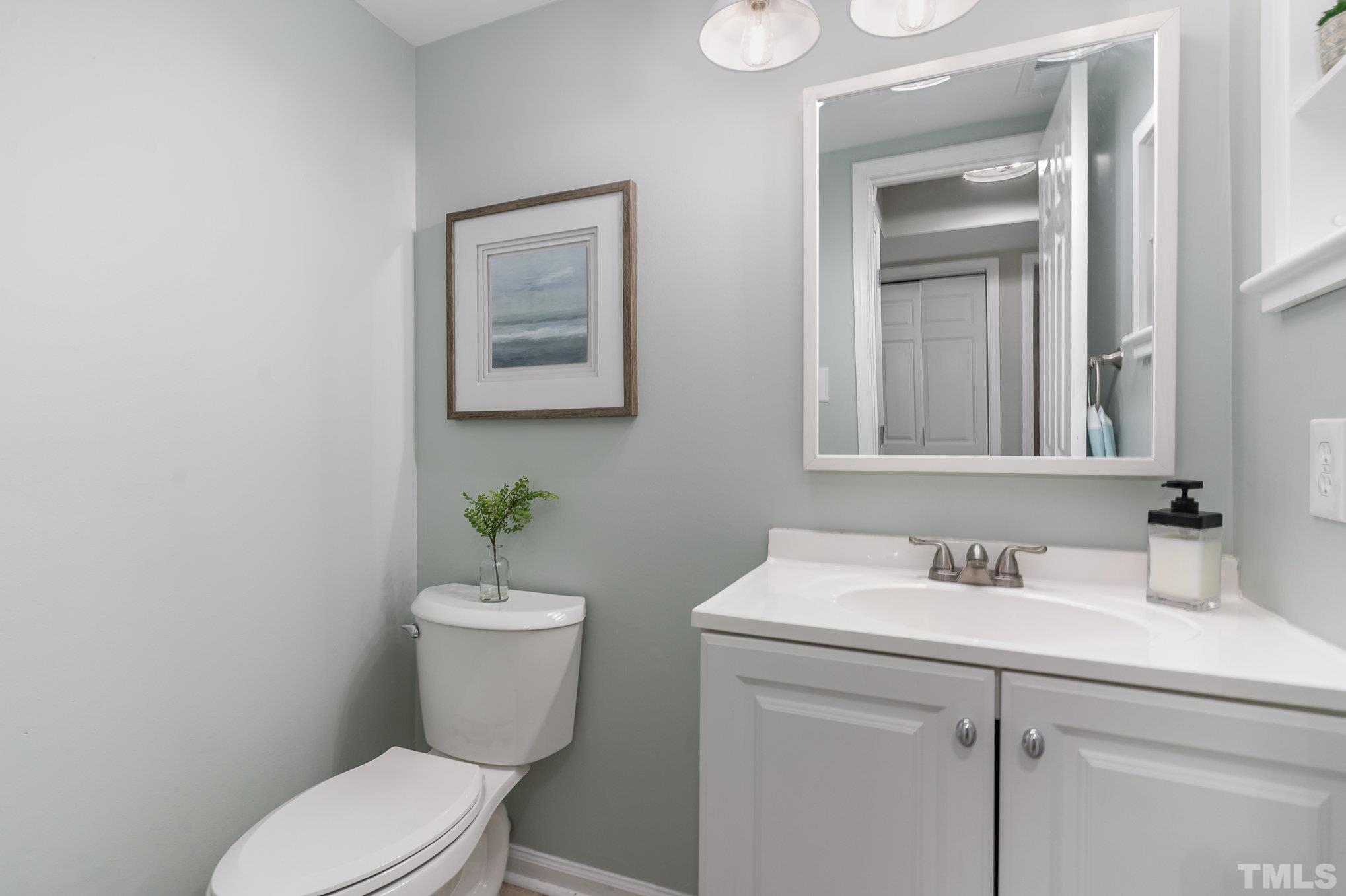 2014 Talloway Drive Cary, NC 27511 - Photo 7 of 18 a bathroom with a sink mirror and toilet