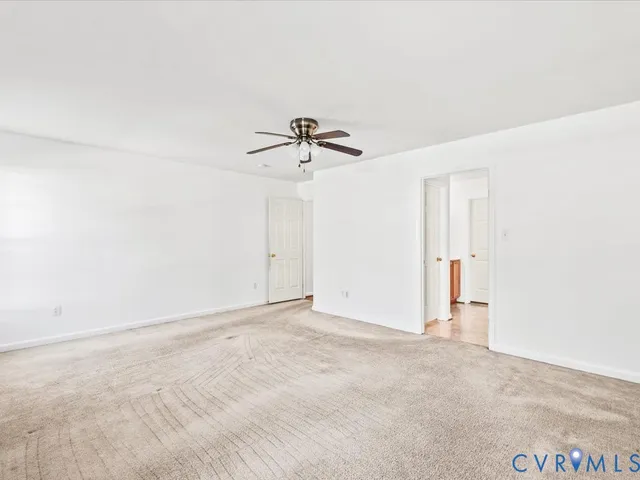 a view of a room with a ceiling fan