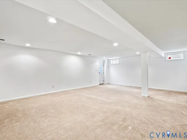 an empty room with a empty space and windows