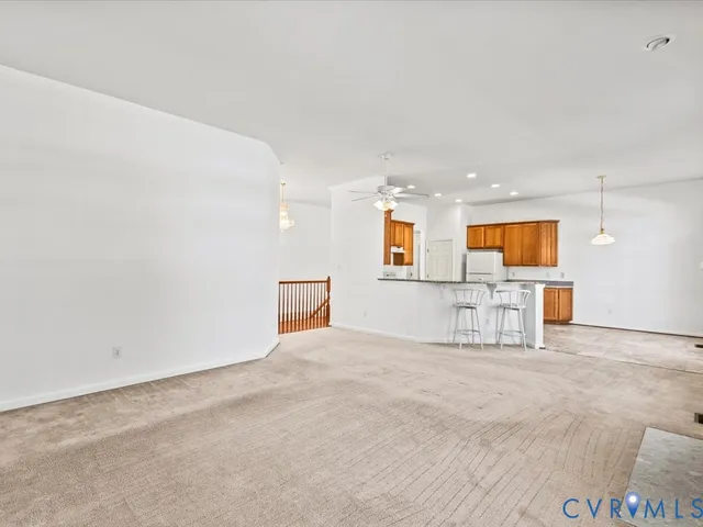 a view of a livingroom with wooden floor and white walls