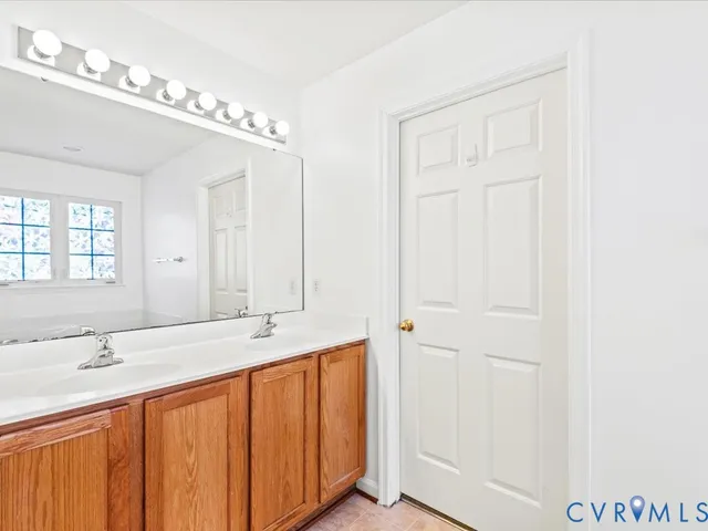 a bathroom with a double vanity sink and a mirror