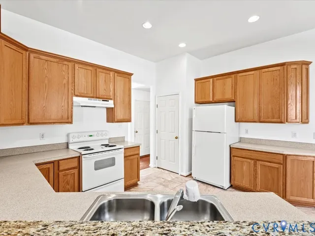 a kitchen with a sink cabinets and appliances