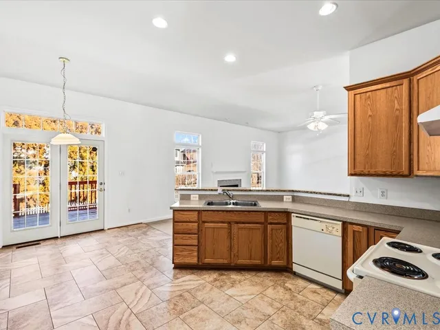 a kitchen with a sink stove and cabinets
