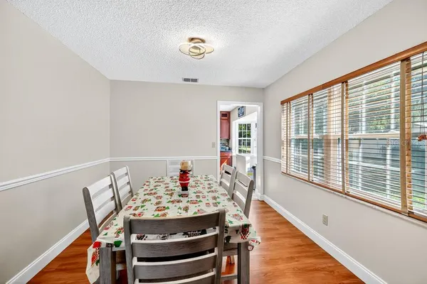 a view of a dining room with furniture window and wooden floor