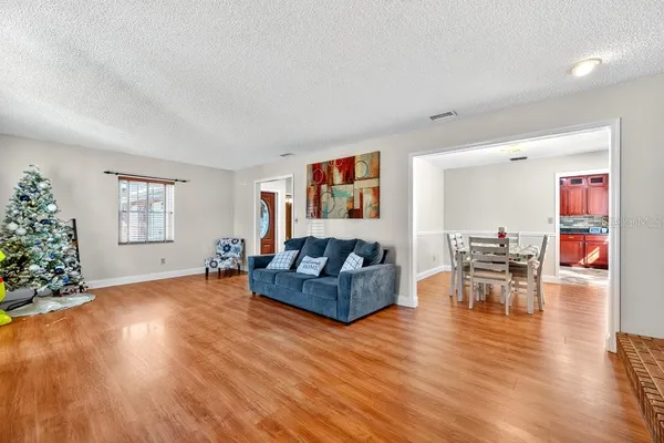 a living room with furniture and wooden floor